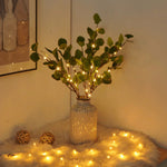 Olive branch with decorative lights — view 1